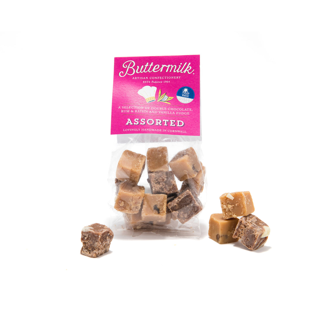 packet of buttermilk assorted fudge with pieces scattered on white background.