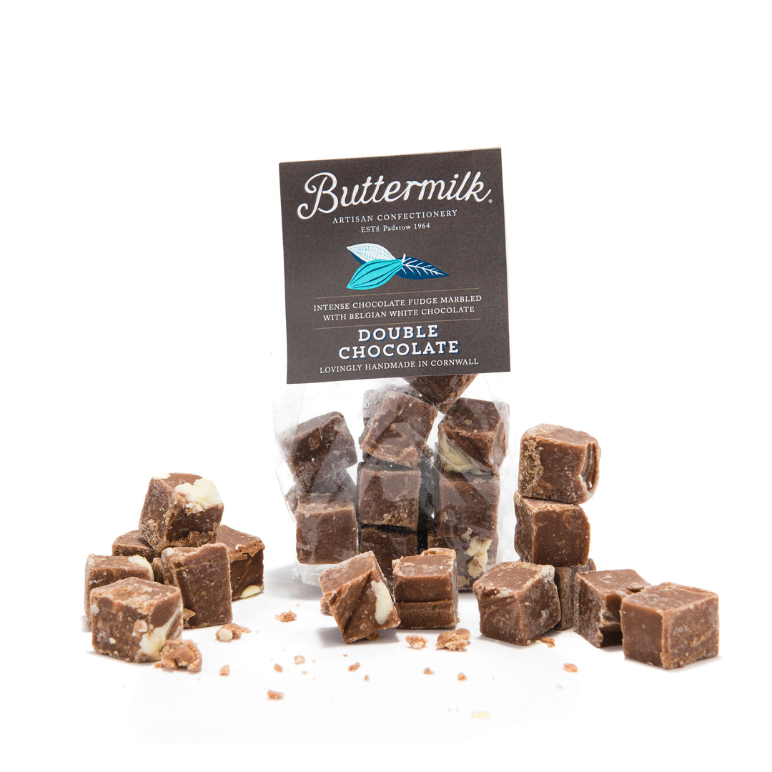 packet of chocolate buttermilk fudge with pieces placed on white background.