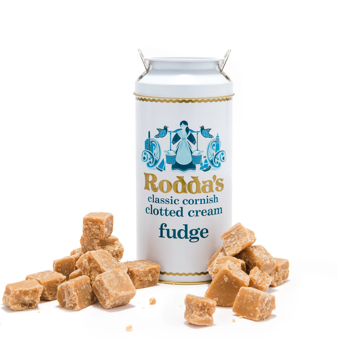 a tub of roddas fudge with pieces scattered outside.